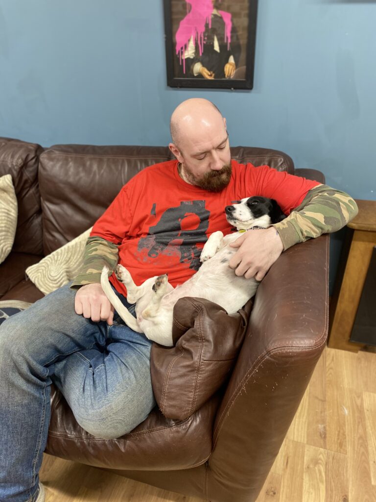 Al cuddling dog
